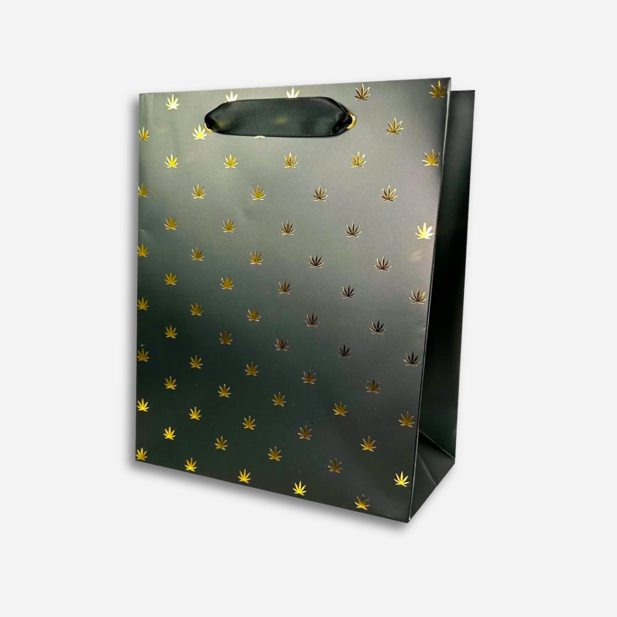 Black gift bag with gold foil cannabis leaf pattern and black ribbon handles.