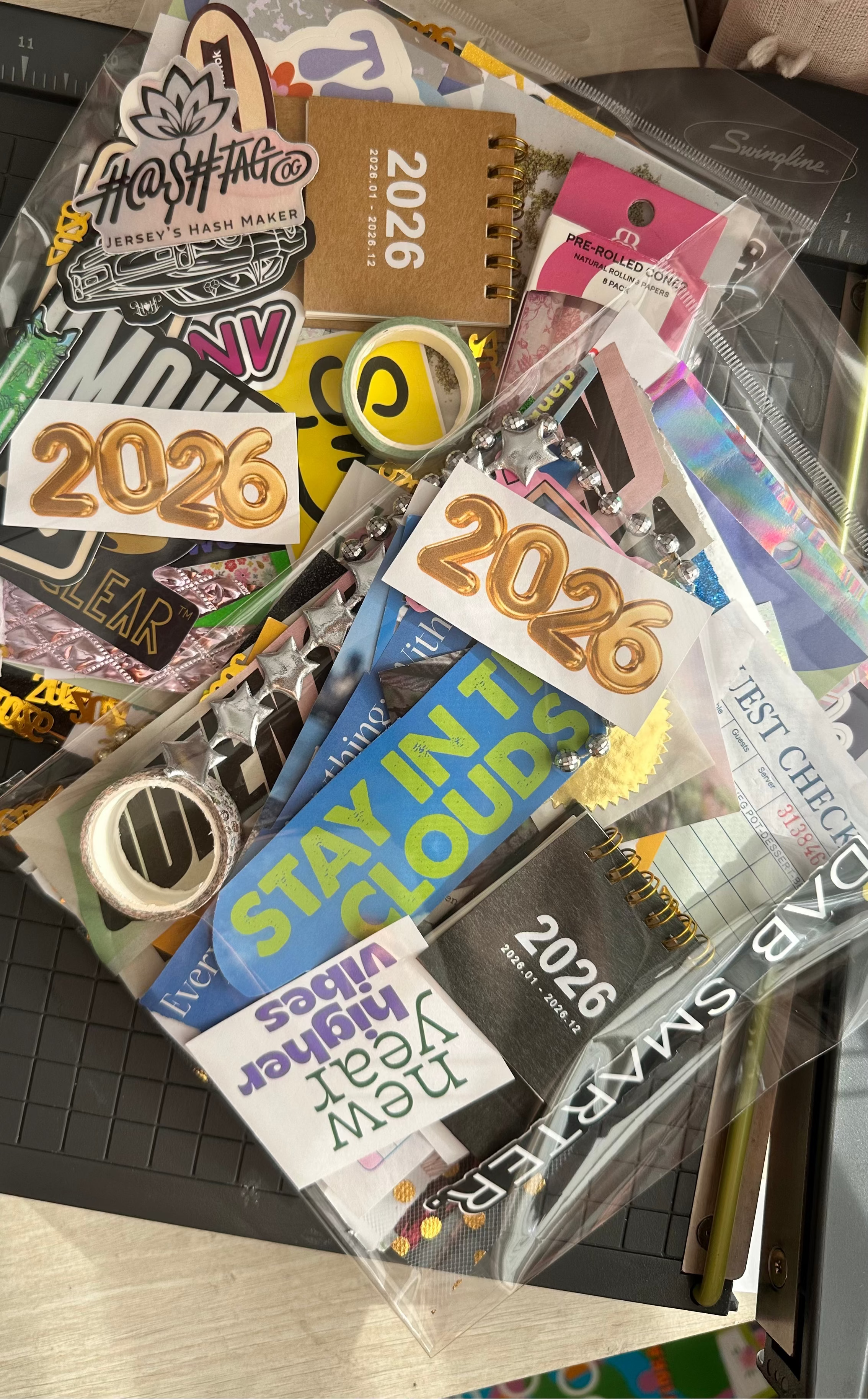 Collection of various stickers with different designs and text on a clear surface.