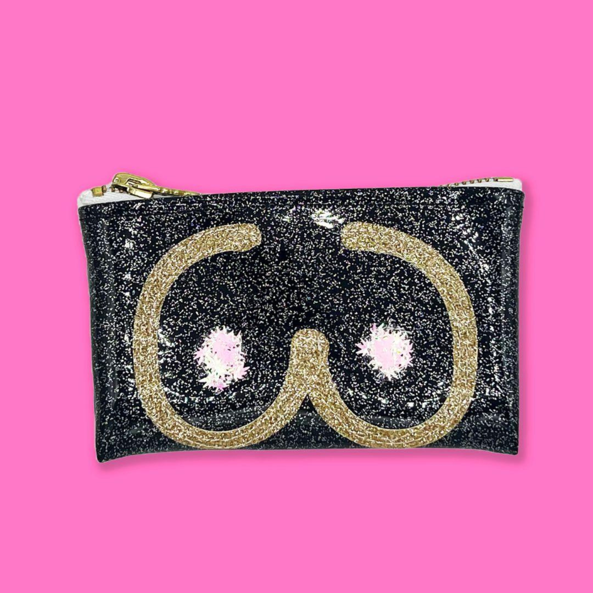 Black glittery keychain clutch with gold boobie silhouette and pink leaf confetti on a pink background.