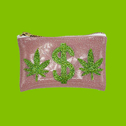  Pink glitter vinyl keychain clutch with green glitter cannabis leaf and dollar sign appliqué on a bright green background.