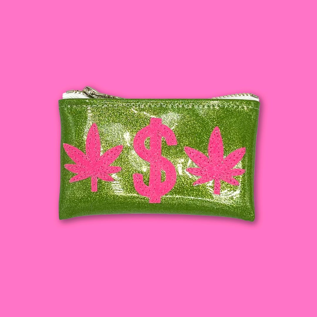 Green glitter vinyl keychain clutch with pink glitter cannabis leaf and dollar sign appliqué on a bright green background.
