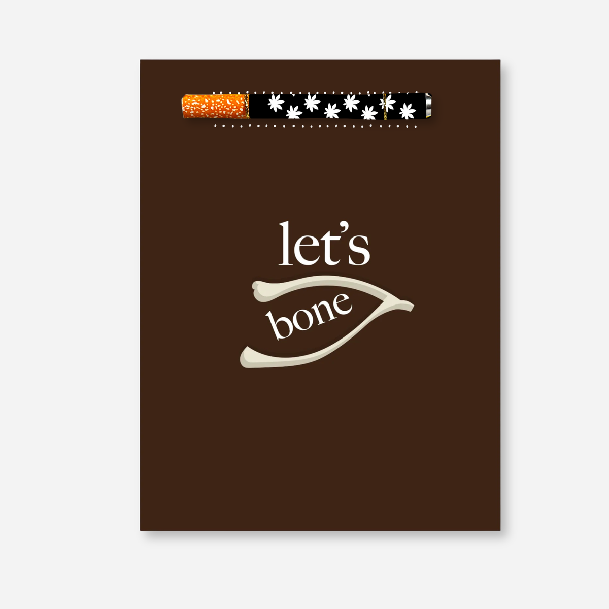 Let’s Bone KushKards greeting card featuring a rich brown background with cream lettering that reads “let’s bone” and a wishbone illustration in the center. A matching aluminum one-hitter pipe with a black-and-white floral leaf pattern and orange-speckled tip is attached near the top of the card.