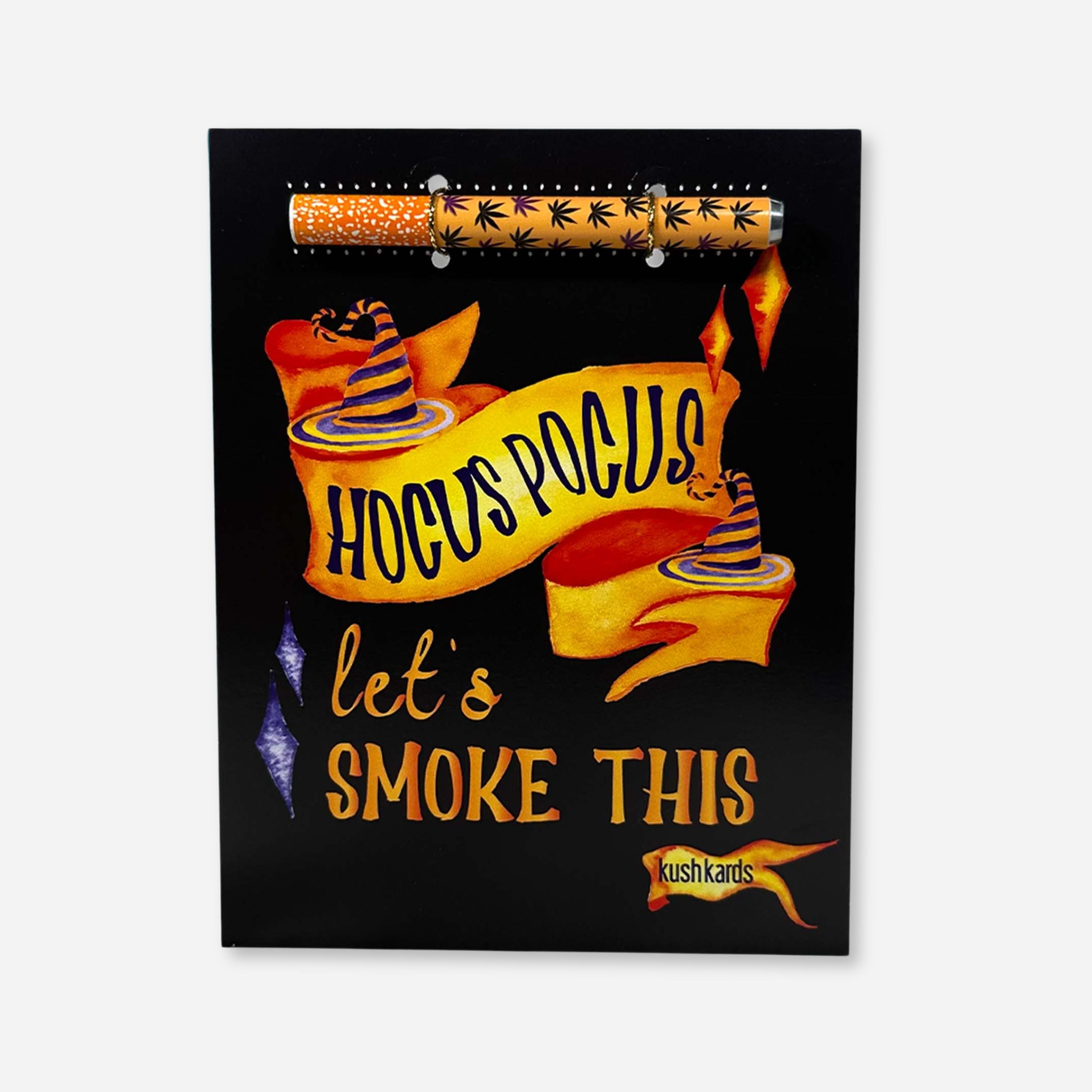 A black greeting card with orange and purple text saying "Hocus Pocus let&
