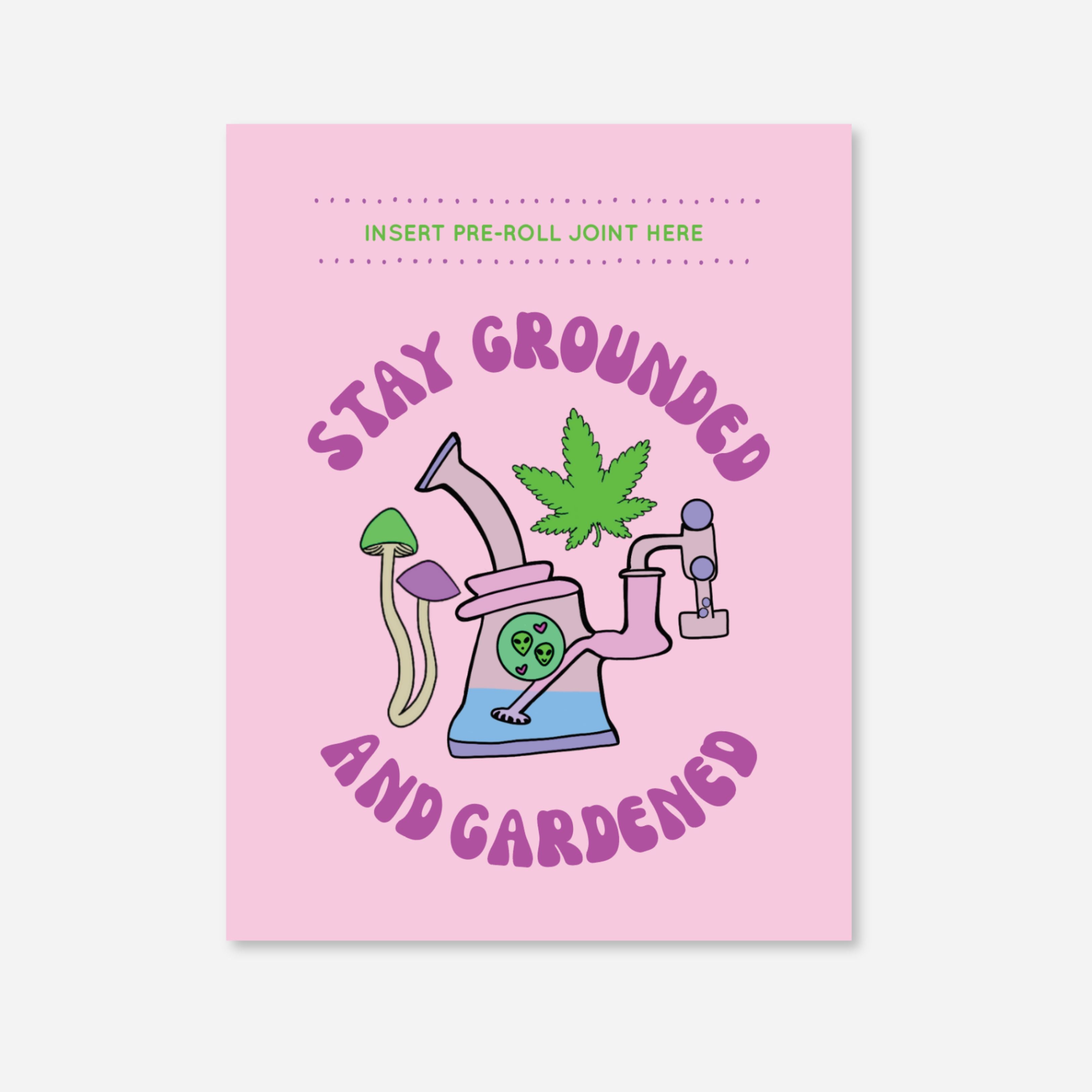 Pink greeting card with mushrooms, cannabis leaf, and a rig illustration that says “Stay Grounded and Gardened.” Features slot for pre-roll and includes matchbook. Art by A Psychedelic Mood.