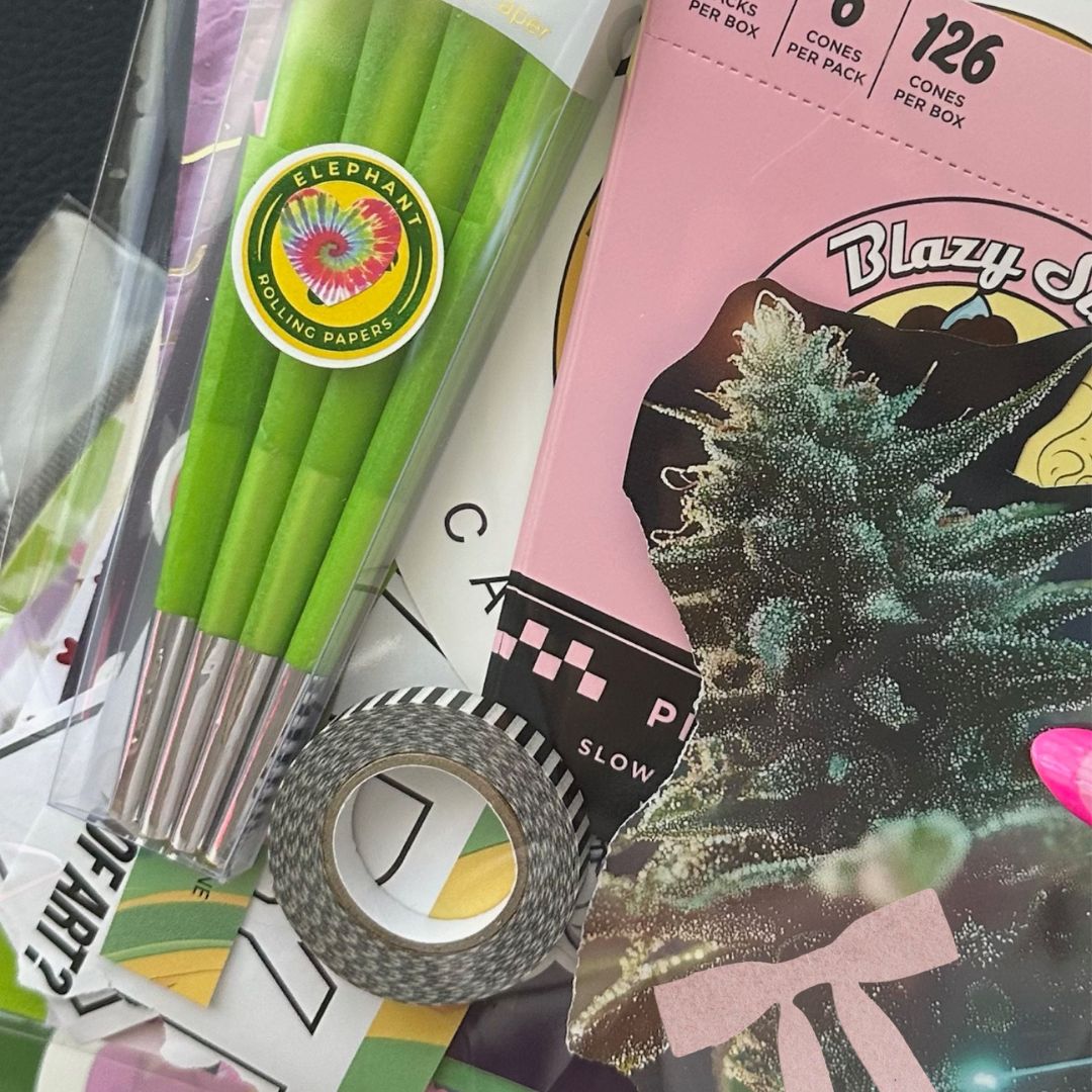 Image of stationery subscription pack wit color pencils , tape, magazine scraps and a name tag with letter beads, rolling paper cones