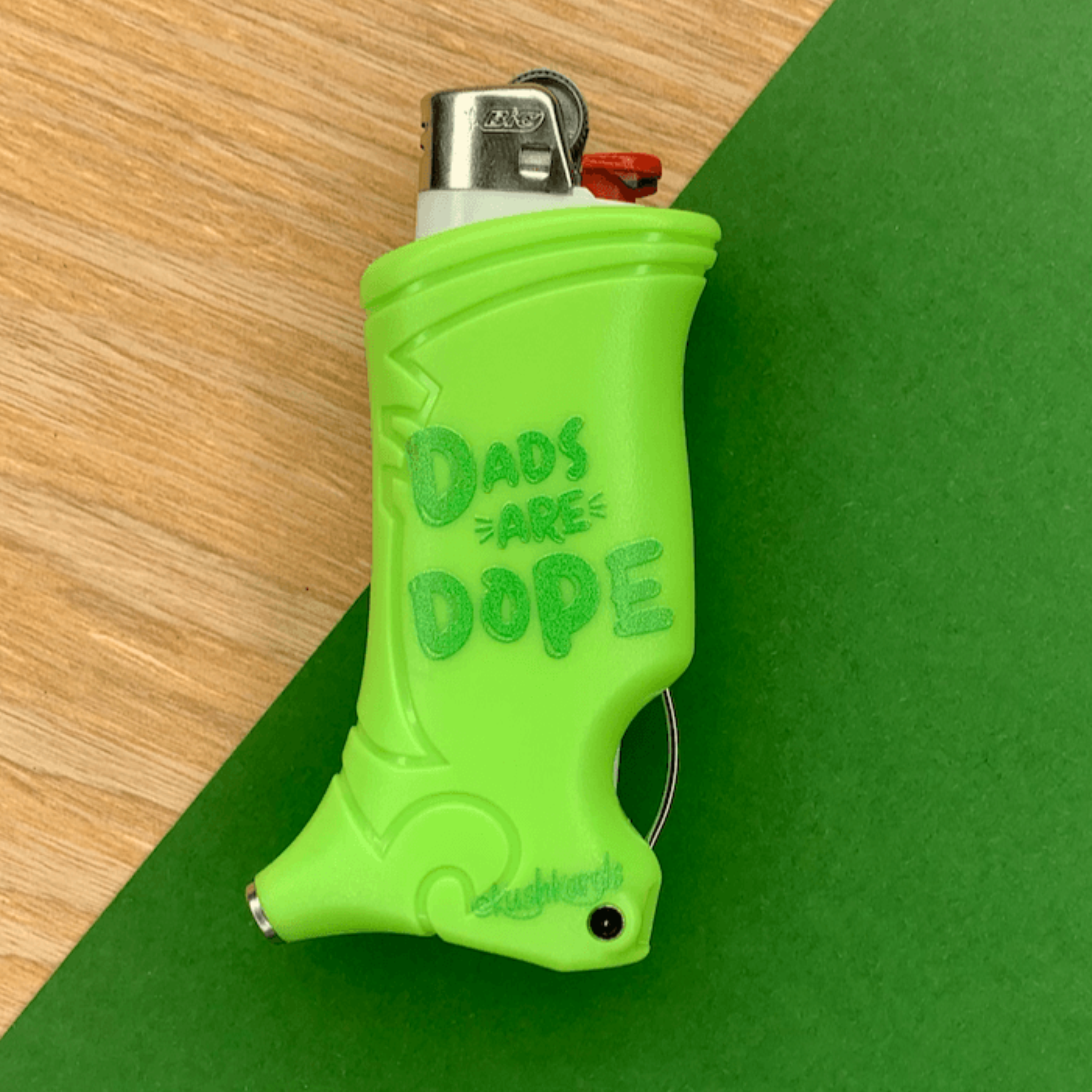Close-up of Dope Dad Toker Poker Lighter Case on a green background with the message "Dads Are Dope."