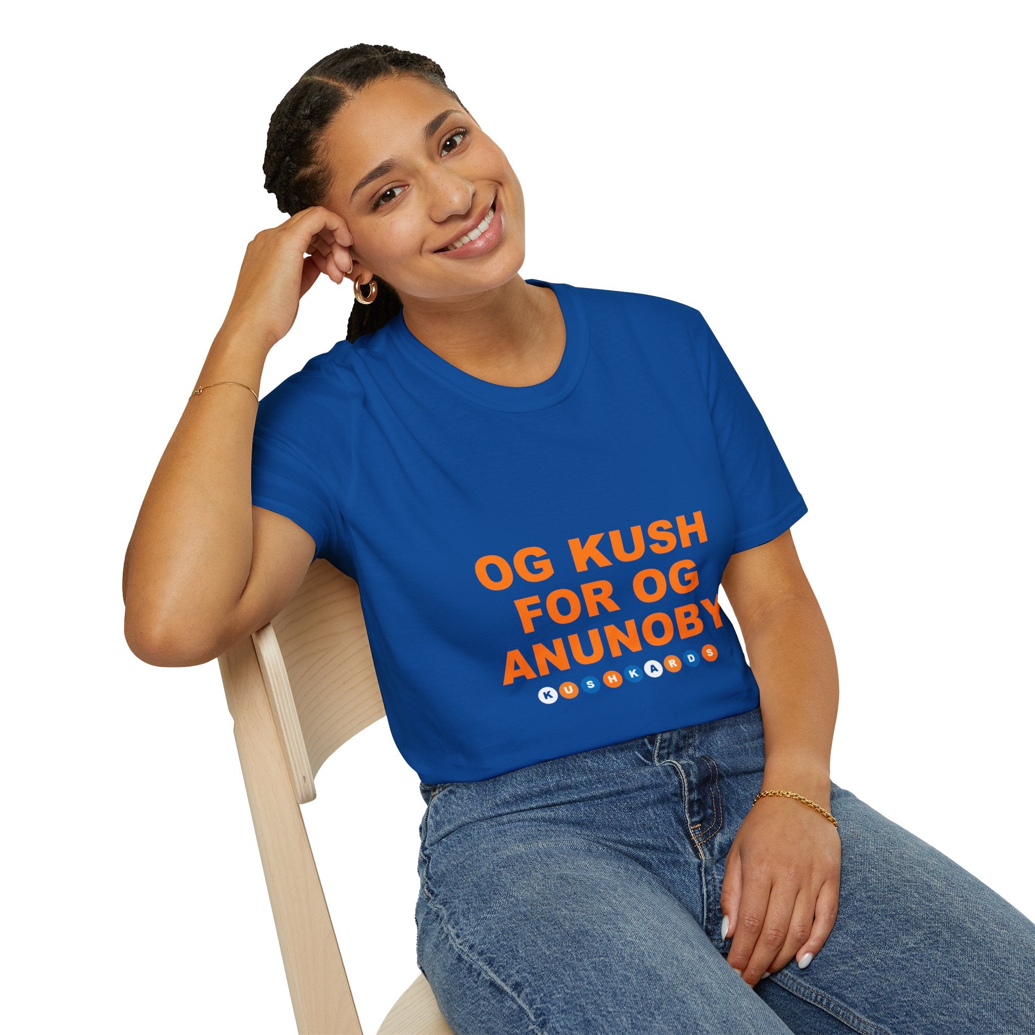 Person wearing a blue t-shirt with orange text sitting on a chair.