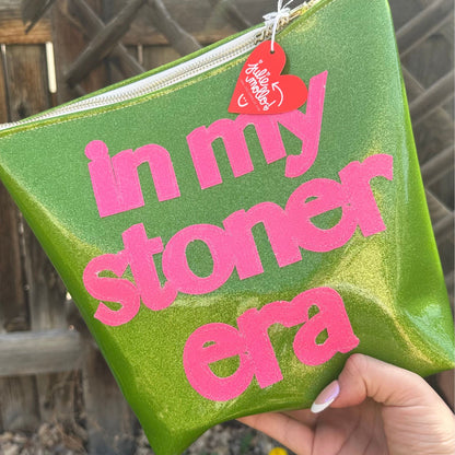 Green travel bag with bold pink cannabis leaf, the ideal companion for the chic and eco-conscious traveler. and pink words&quot; in my stoner era&quot;