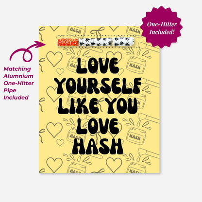 Yellow greeting card that says “Love Yourself Like You Love Hash,” featuring a built-in aluminum one-hitter pipe. Background includes hearts and hash-themed illustrations. Collaborative art by A Psychedelic Mood.
