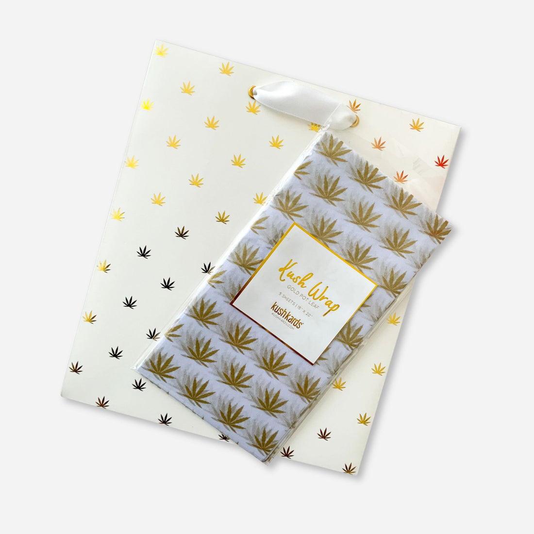White gift bag and matching gold pot leaf tissue paper combo set, perfect for elevated cannabis-themed gifting