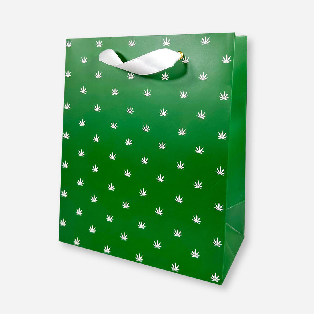 green gift bag with white foil cannabis leaf pattern and white ribbon handles.