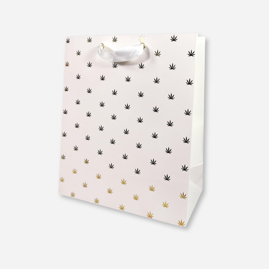 White gift bag with gold foil cannabis leaf pattern and white ribbon handles.