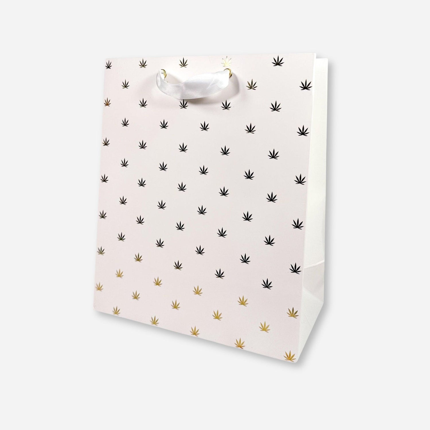 White gift bag with gold foil cannabis leaf pattern and white ribbon handles.