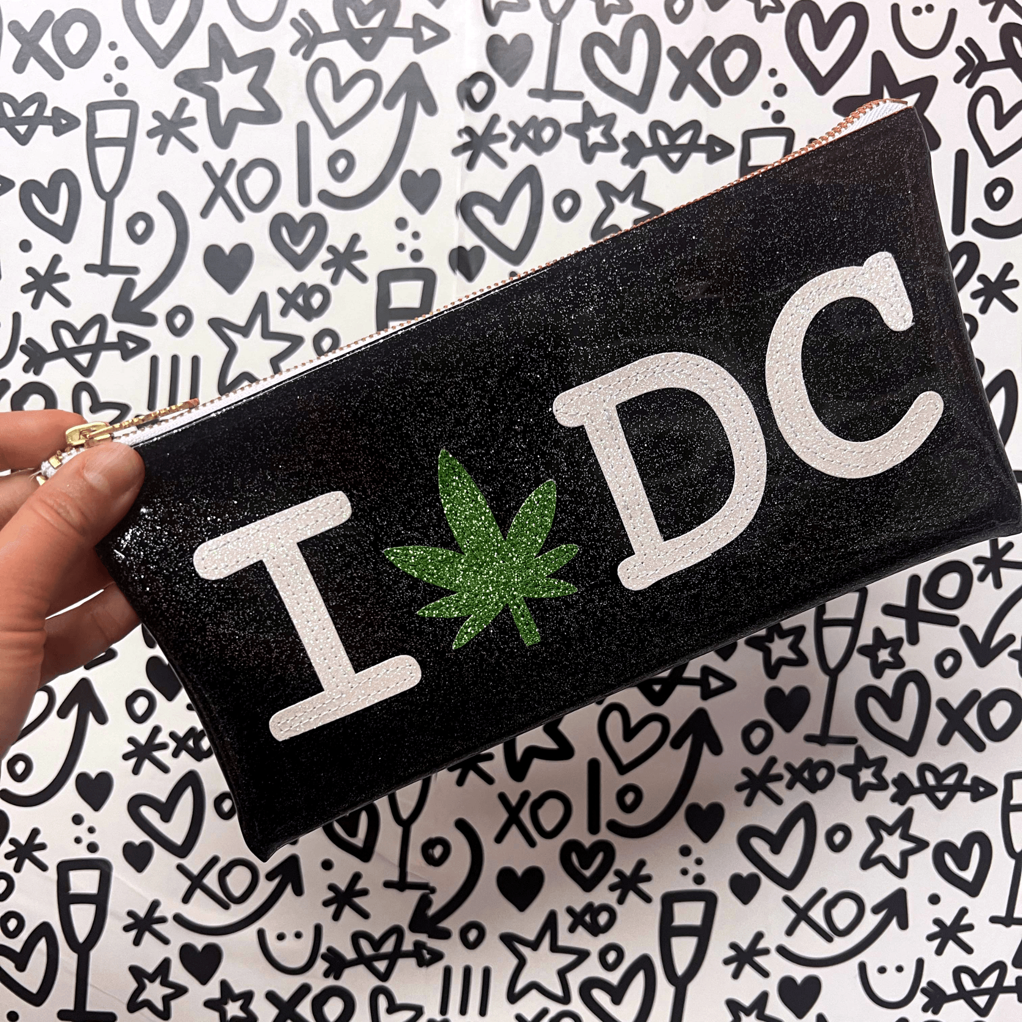 Personalized black glitter clutch featuring &