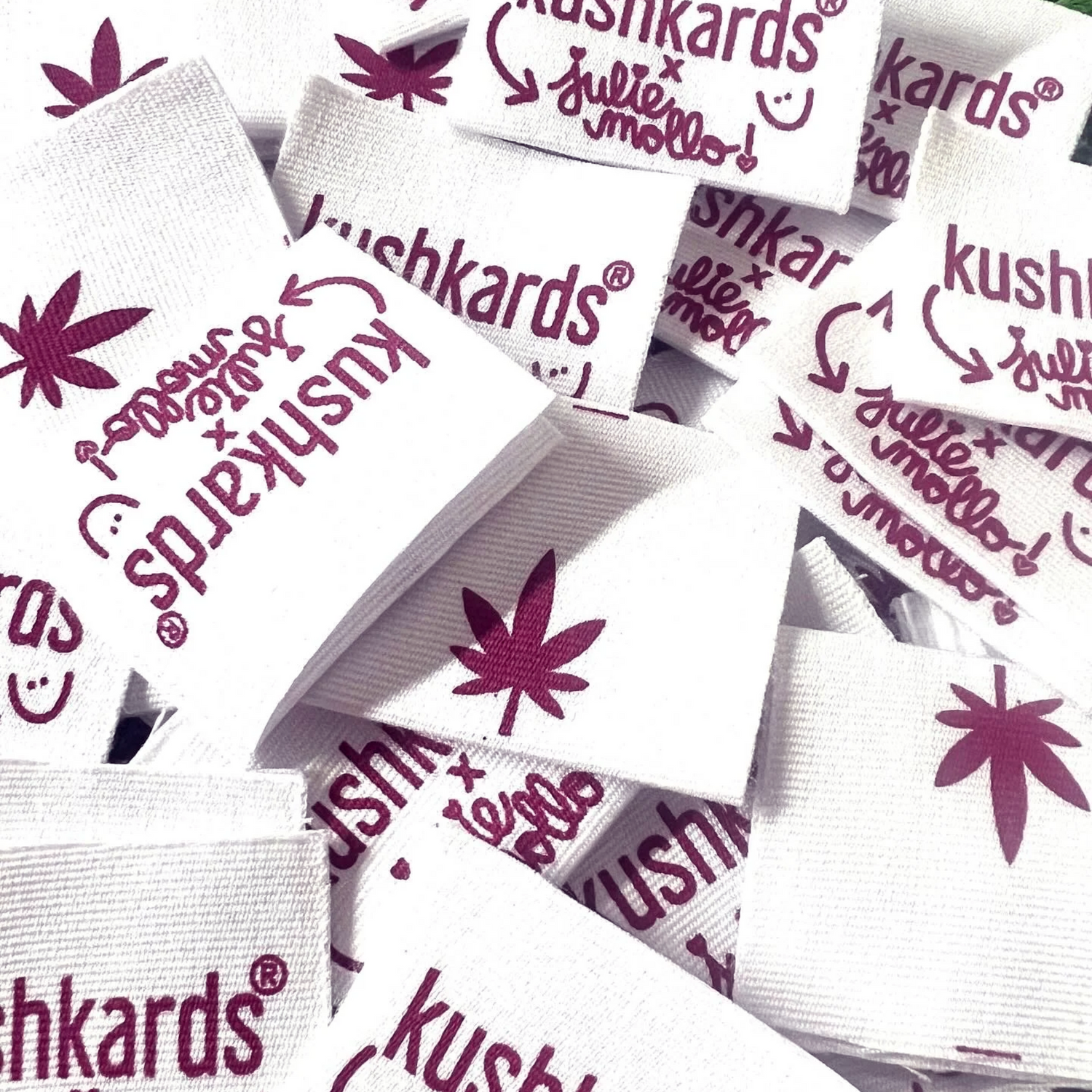 Close-up of custom clutch tags from KushKards, showcasing the collaboration with Julie Mollo.