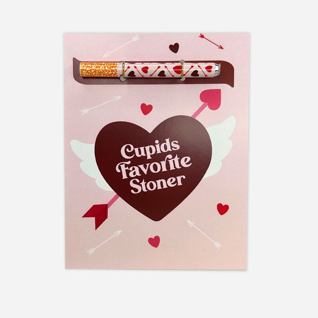 A romantic and whimsical greeting card in pastel pink, adorned with a heart-shaped chocolate box reading &
