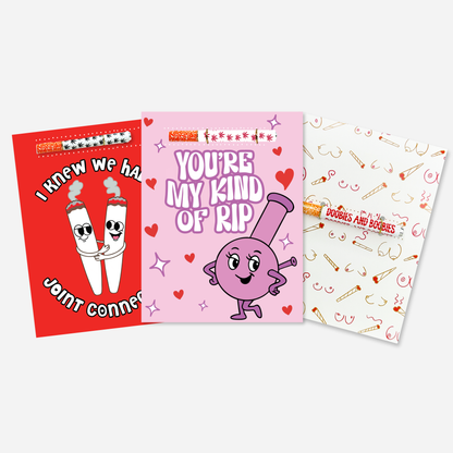 Valentine’s Day KushKards greeting card assortment featuring three cannabis-themed designs with matching one hitters 