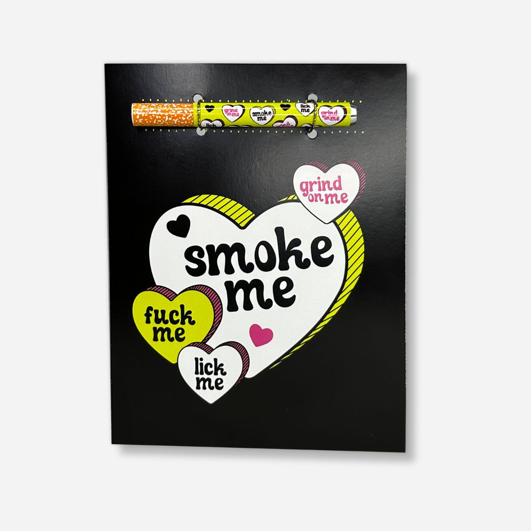 A bold black greeting card featuring a large white heart with playful yellow trim, surrounded by smaller hearts with flirtatious phrases like &