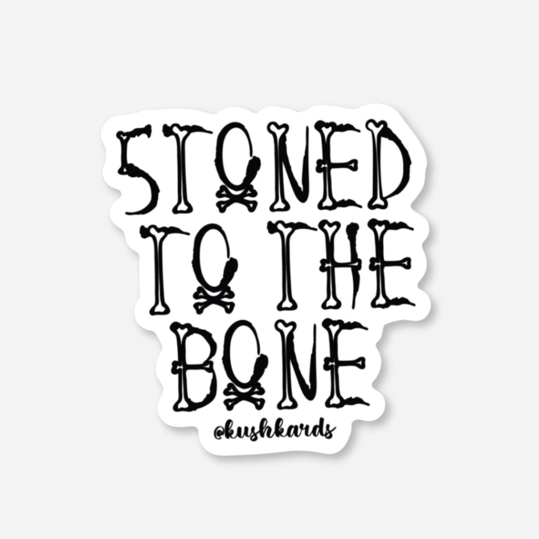 White matte sticker with &quot;STONED TO THE BONE&quot; text made from bones and skull &amp; crossbones.