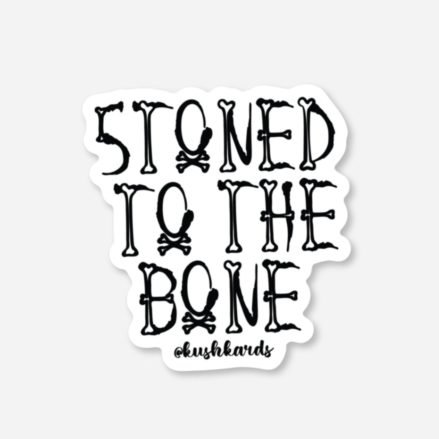White matte sticker with &quot;STONED TO THE BONE&quot; text made from bones and skull &amp; crossbones.