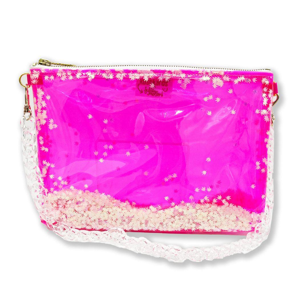 The cutest clear pink stoner girlie shoulder bag you ever did see! The best galentines gift for your BEST BUD or even your clearest, cutest way into a concert or event with a clear bag policy!   10x7.5x1.5” 2 brass D rings on either side of clutch 10” brass zipper with xoxo zipper pull 20” clear acrylic chain strap! Hot pink clear vinyl is easy to disinfect! Pink & Pearlescent Cannabis Confetti! Designed in collaboration with Kush Kards!