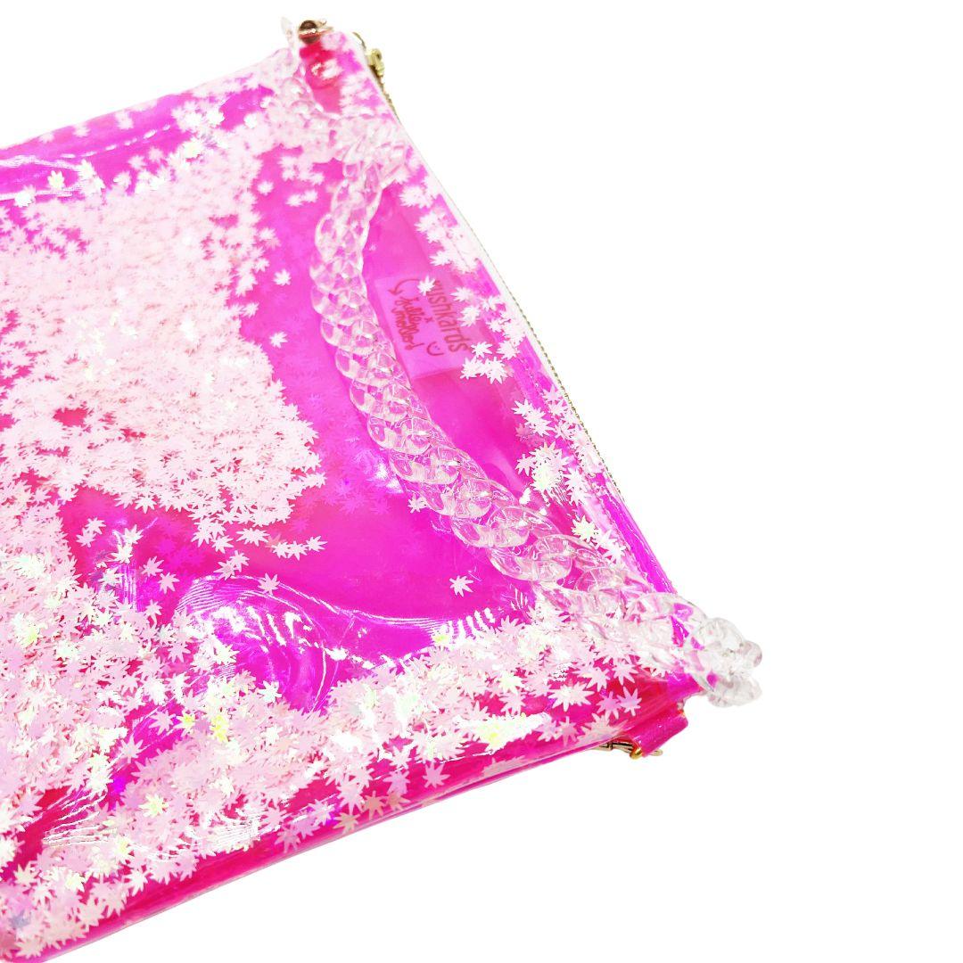 The cutest clear pink stoner girlie shoulder bag you ever did see! The best galentines gift for your BEST BUD or even your clearest, cutest way into a concert or event with a clear bag policy!   10x7.5x1.5” 2 brass D rings on either side of clutch 10” brass zipper with xoxo zipper pull 20” clear acrylic chain strap! Hot pink clear vinyl is easy to disinfect! Pink & Pearlescent Cannabis Confetti! Designed in collaboration with Kush Kards!