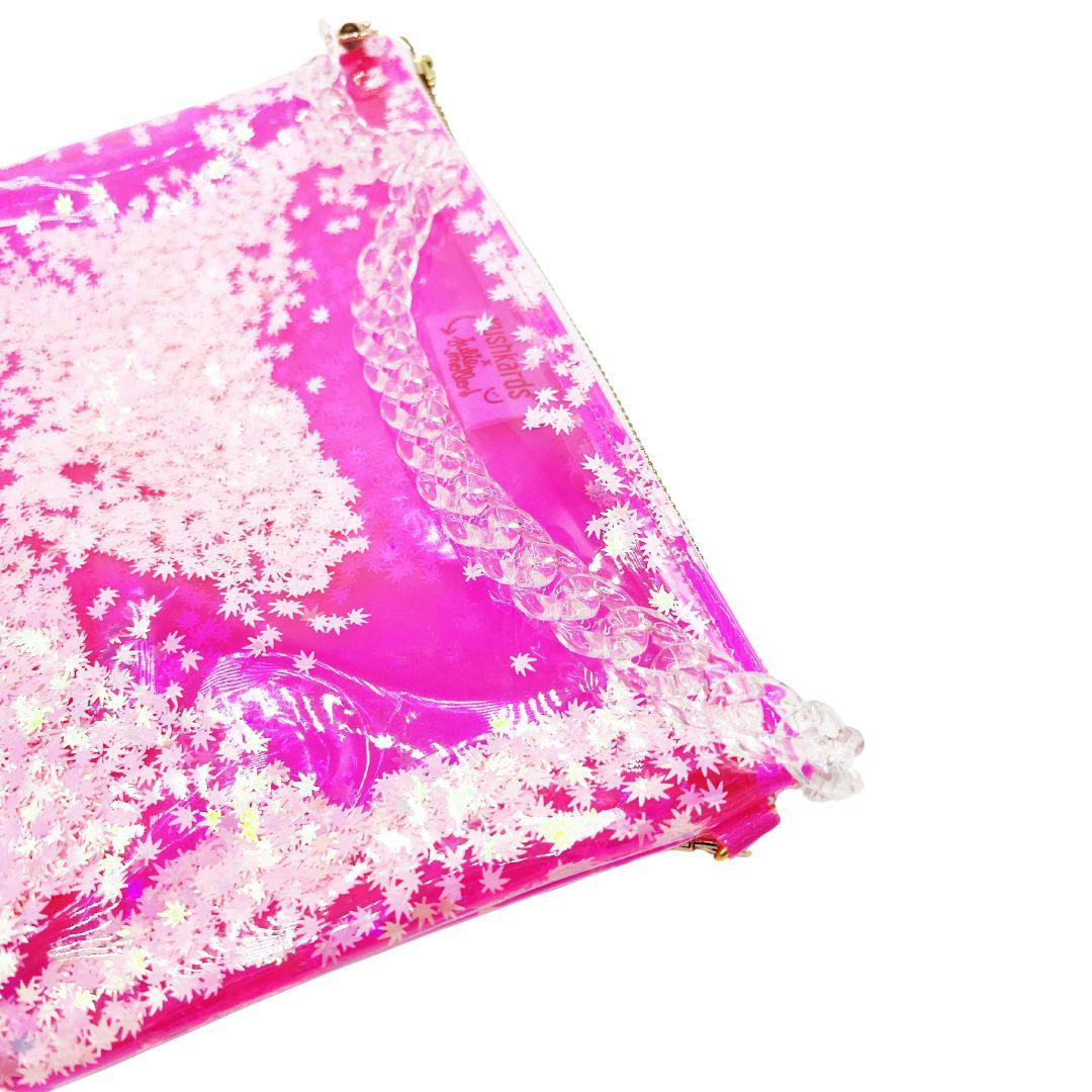 The cutest clear pink stoner girlie shoulder bag you ever did see! The best galentines gift for your BEST BUD or even your clearest, cutest way into a concert or event with a clear bag policy!   10x7.5x1.5” 2 brass D rings on either side of clutch 10” brass zipper with xoxo zipper pull 20” clear acrylic chain strap! Hot pink clear vinyl is easy to disinfect! Pink &amp; Pearlescent Cannabis Confetti! Designed in collaboration with Kush Kards!