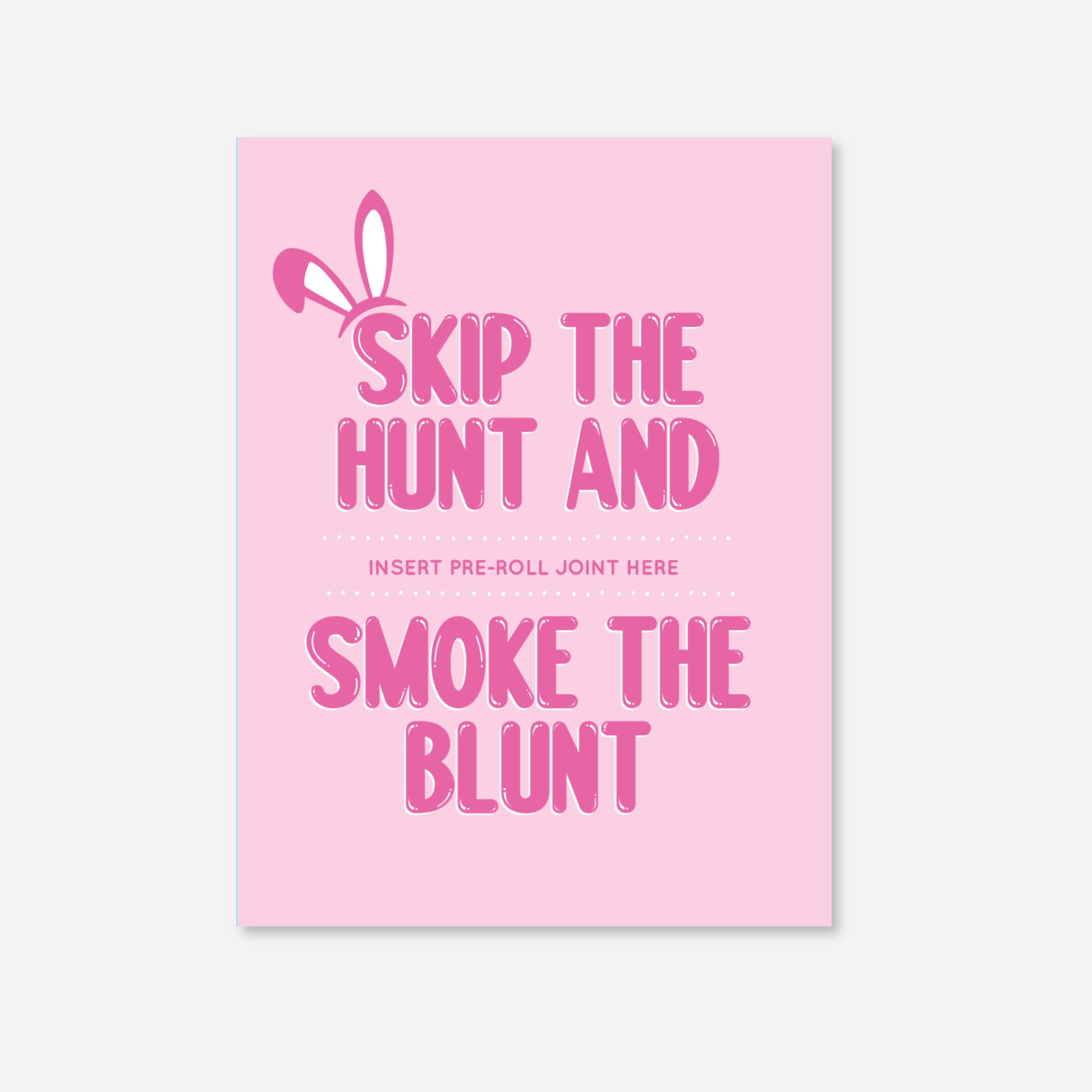 Pink greeting card with playful white bunny ears graphic and bold pink typography reading “Skip the Hunt and Smoke the Blunt.” The design features a dotted line for inserting a pre-roll joint. Fun and festive cannabis-themed card for spring celebrations. with a slot to insert a pre roll and matchbooks included 
