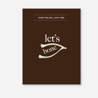 Let’s Bone KushKards greeting card featuring a rich brown background with cream lettering that reads “let’s bone” and a wishbone illustration in the center. A slot near the top is labeled “Insert Pre-Roll Joint Here” for adding a pre-rolled item of choice. 