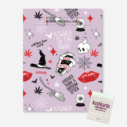 A light purple greeting card with a Halloween-themed pattern of cannabis leaves, witch hats, brooms, skulls with candles, spiderwebs, bats, red lips, and text like &quot;witches love weed,&quot; &quot;STONED TO THE BONE,&quot; &quot;SLAY &amp; COUGH,&quot; and &quot;HIGHER THAN A BROOM STICK.&quot; At the top, there&