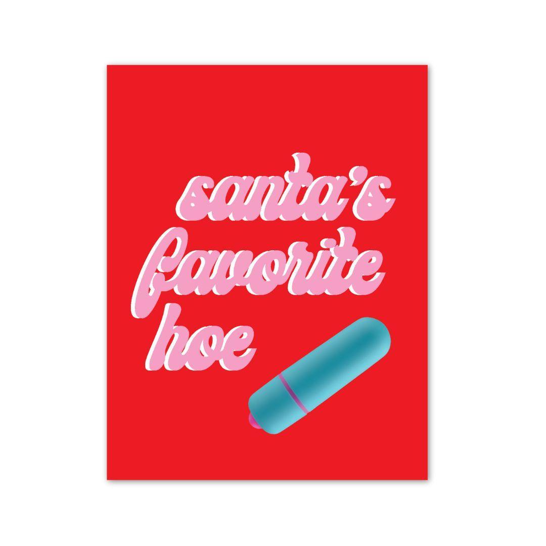 A playful and festive greeting card with a bold red background, featuring the tongue-in-cheek phrase ‘Santa’s Favorite Hoe’ in whimsical pink script, with an attached blue vibrator adding a naughty twist to the holiday cheer.