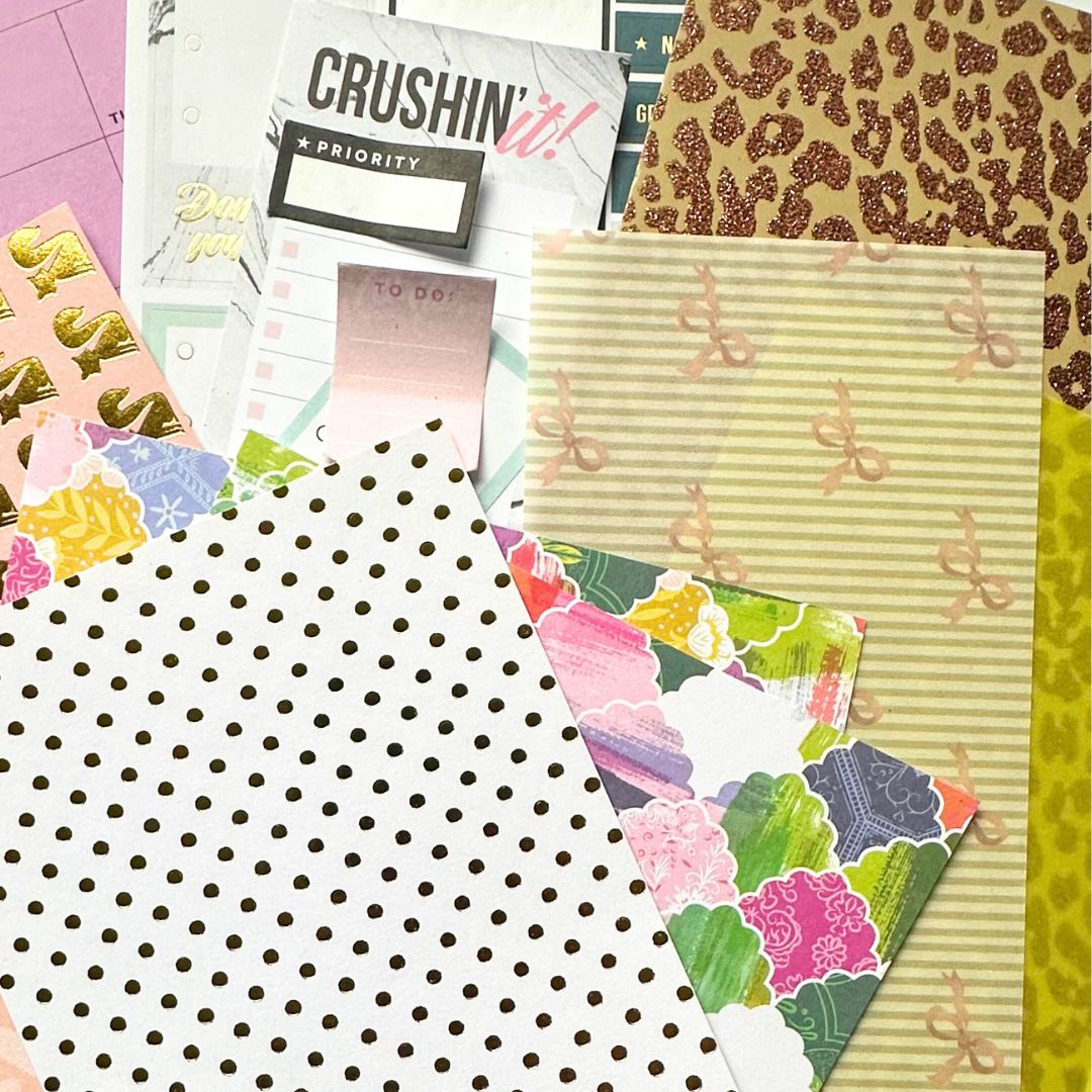 Assorted thrifted papers in pastel and glitter textures, featuring polka dots, bows, floral patterns and retro designs for creative stoners