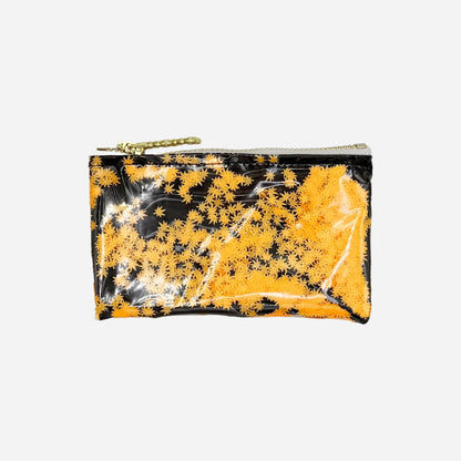 A small rectangular zip pouch with a glossy finish, featuring a black and orange pot leaf pattern, with a gold zipper and chain pull, shown on a plain white background.