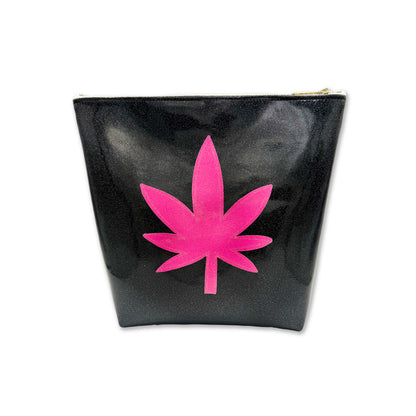 Black travel bag with a pink cannabis leaf design on a white background