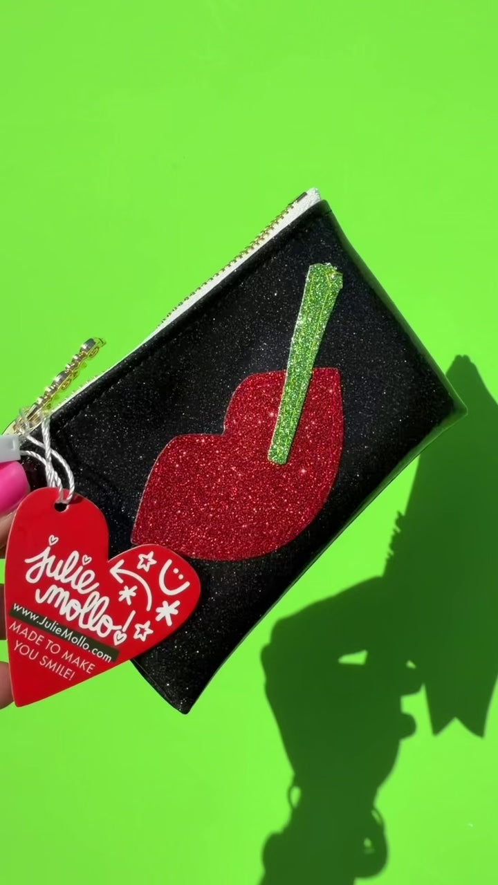 video of lady j keychain clutch on green background 