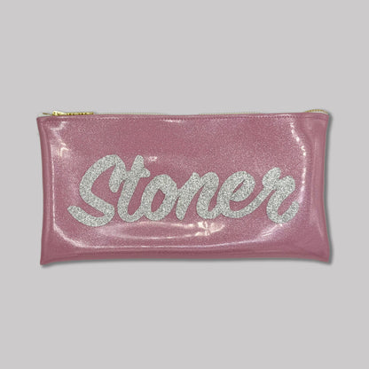 A pink glittery zippered pouch with the word &