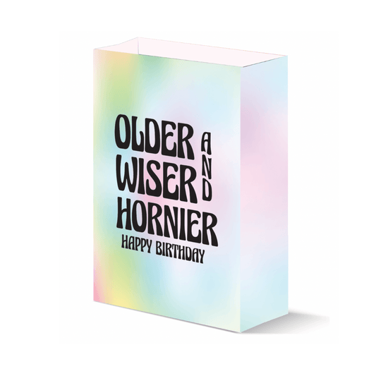 Colorful tie-dye birthday gift bag with 'Older, Wiser, Hornier, Happy Birthday' message, perfect for gifting with a playful touch.