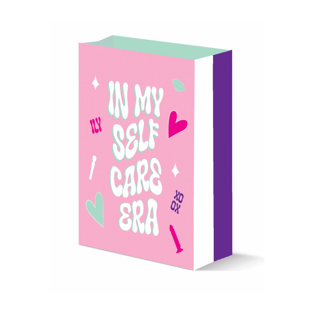 A vibrant pink gift bag with the phrase 'IN MY SELF CARE ERA' in playful white lettering, accented with doodles of hearts, embodying a fun and modern approach to self-love and personal pampering.